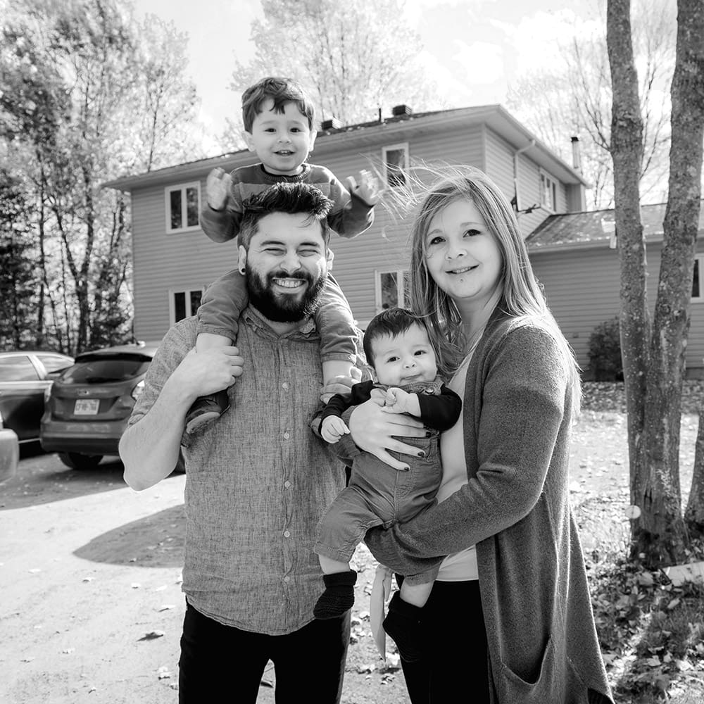 Young family outside their home